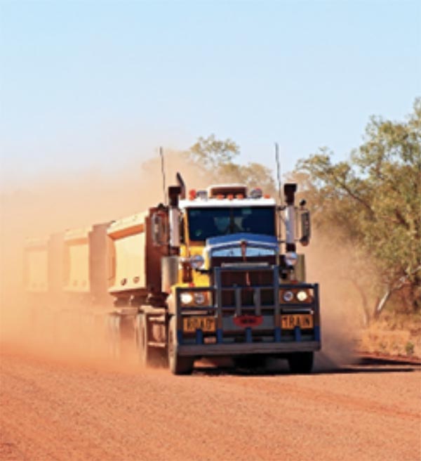 Front view of a road train on a dirt road